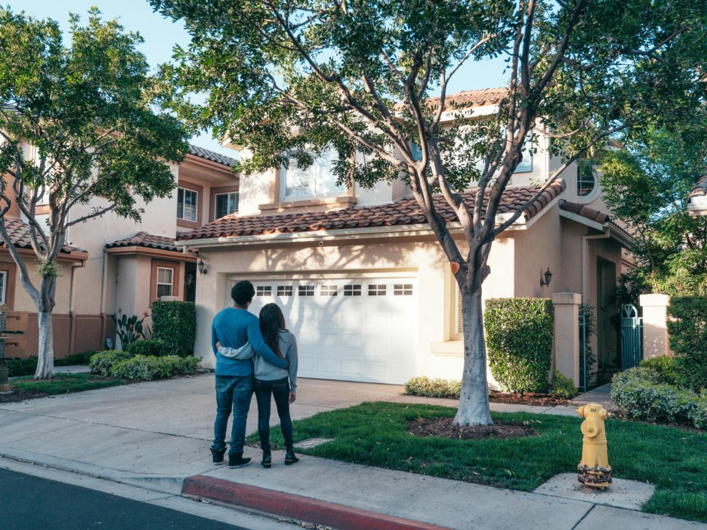 Photo by Kindel Media: https://www.pexels.com/photo/couple-standing-in-front-of-their-house-7579042/