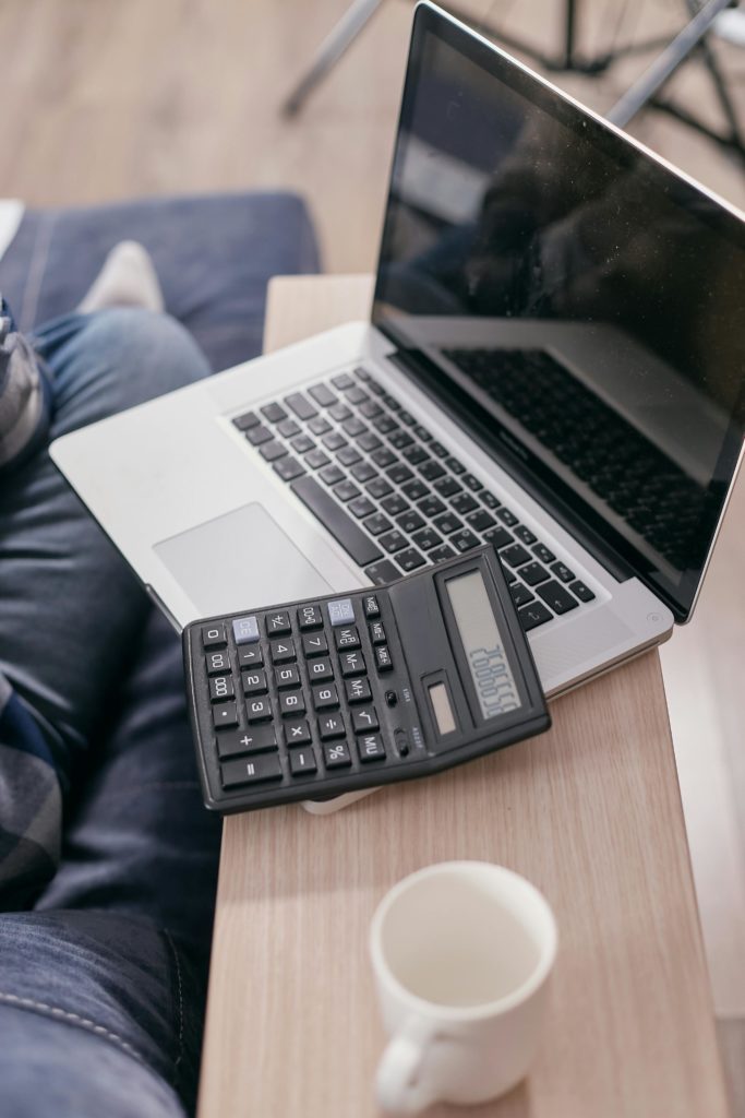 Photo by Mikhail Nilov: https://www.pexels.com/photo/a-laptop-and-calculator-on-a-wooden-table-6963055/